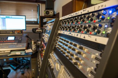 several mixing consoles in a recording studio clipart