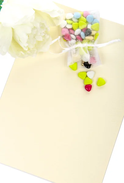 Candy with a white flower laid on a table — Stock Photo, Image