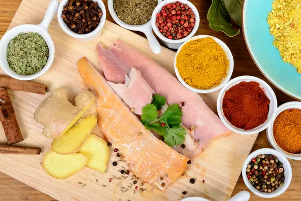 Fish fillet with assortment of spices — Stock Photo, Image