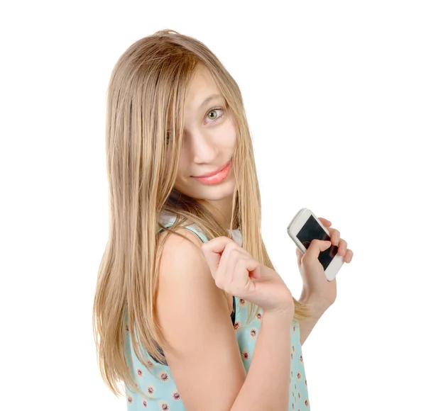 10 代の少女が彼の手で携帯電話の側に立って — ストック写真
