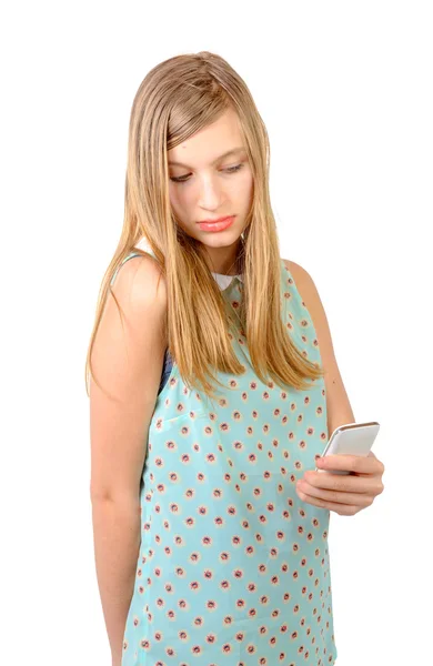 Teenage girl standing with a phone in his hand — Stock Photo, Image