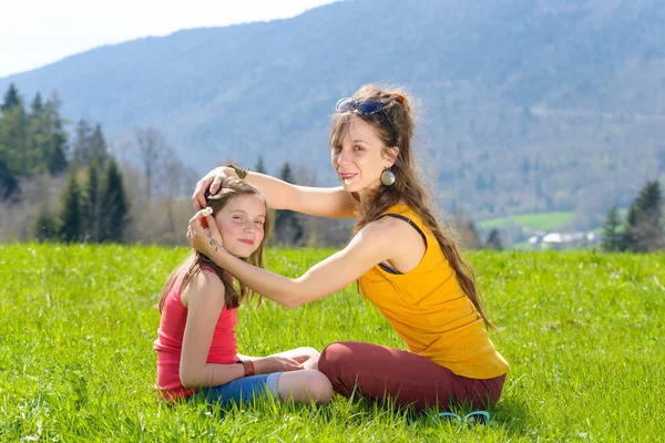 Mom and daughter play with flowers — Stock Photo, Image