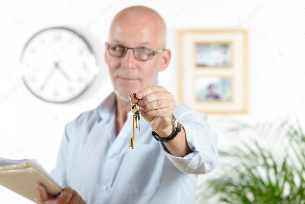 real estate agent gives the keys of the house