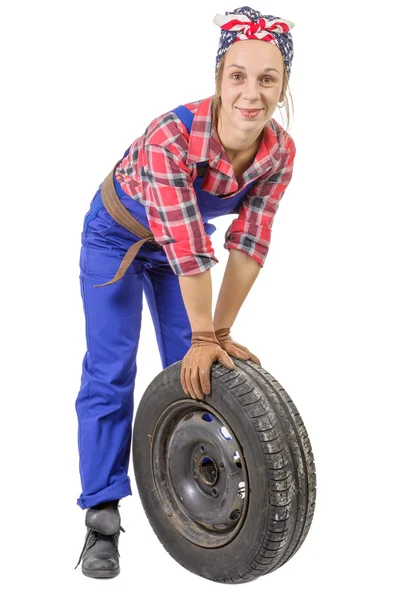 Young woman mechanic with a car wheel — Stock Photo, Image