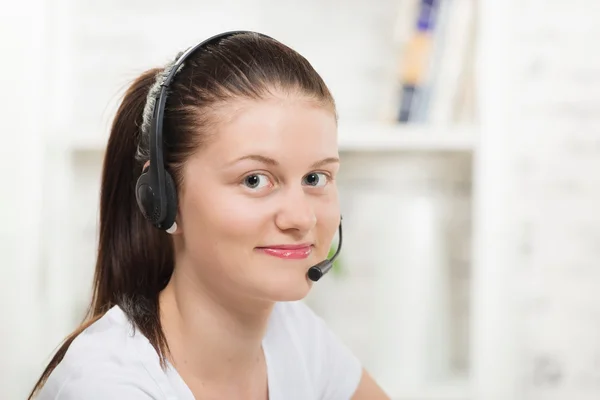 Pretty young woman with a headset — Stock Photo, Image