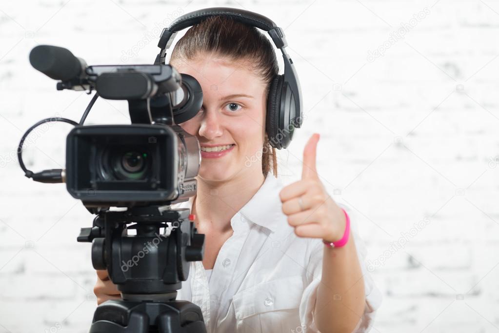 a pretty young woman with a professional camera and headphone