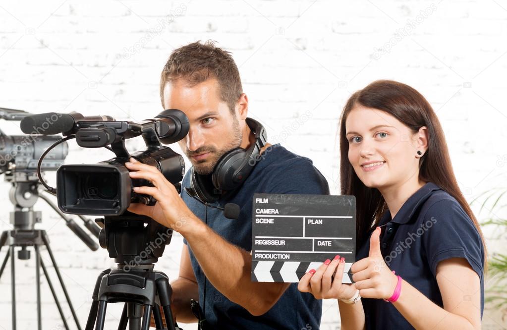 a cameraman and a young woman with a movie camera