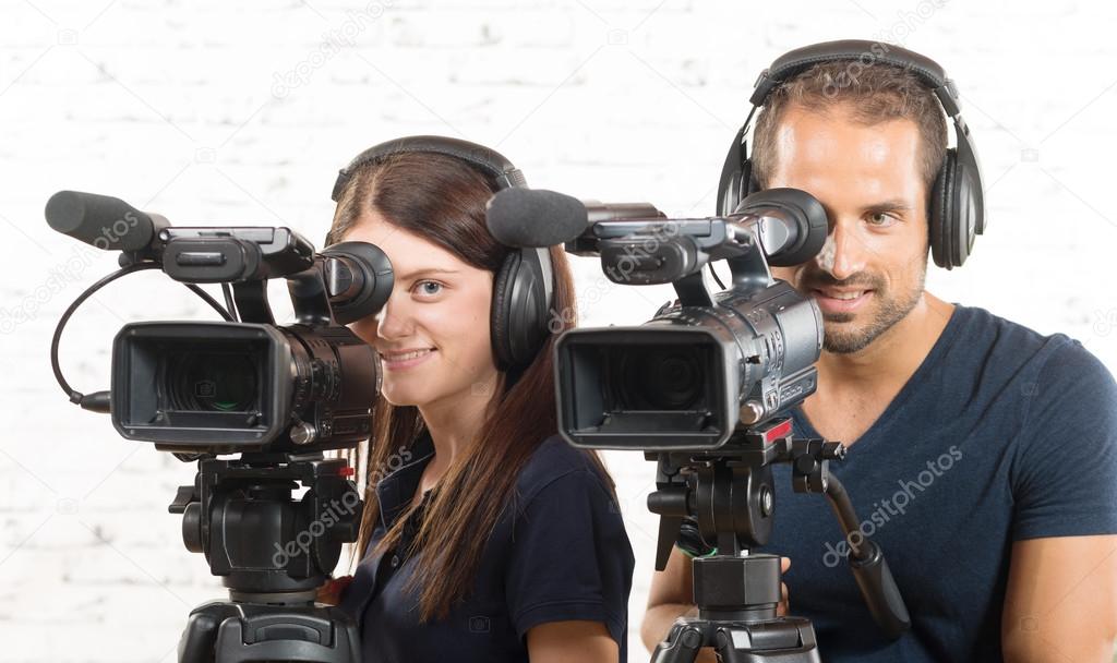 a man and a woman with professional video cameras
