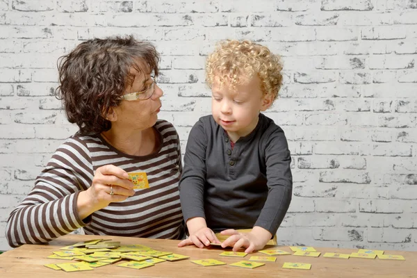 Küçük bir sarışın çocuk onun büyükannesi ile oynamak — Stok fotoğraf