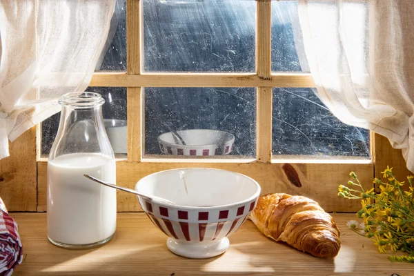 Sunny morning breakfast with milk near a window — Stock Photo, Image