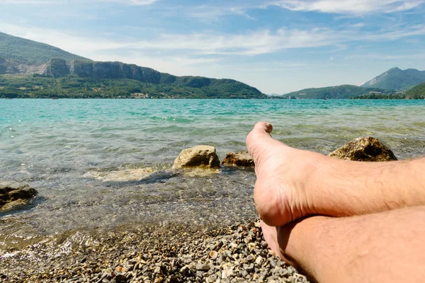 Feet on the beach of lake of Annecy — Stock Photo, Image