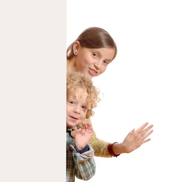 Cute little kids behind a white board — Stock Photo, Image