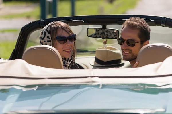 A young couple in a convertible car — Stock Photo, Image