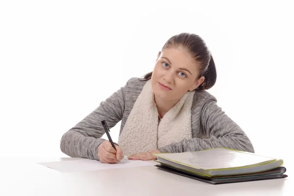 Fiatal nő írás az asztalára elszigetelt fehér background — Stock Fotó