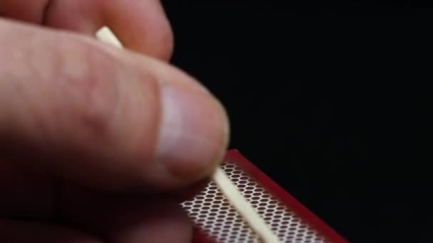 Strike a match on a matches box — Stock Video