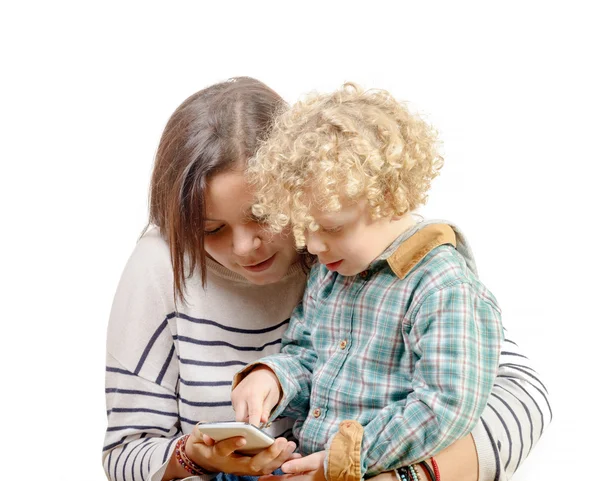 Little blond boy playing with his sister's phone — Stock Photo, Image