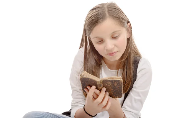 Nahaufnahme eines jungen Teenagers, der im Schneidersitz ein Buch liest — Stockfoto