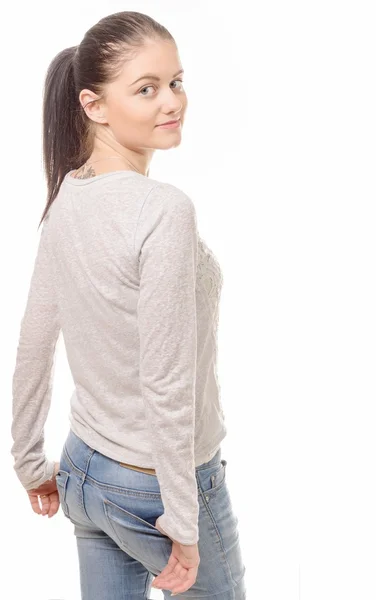 Pretty young woman standing on white background, back view — Stock Photo, Image