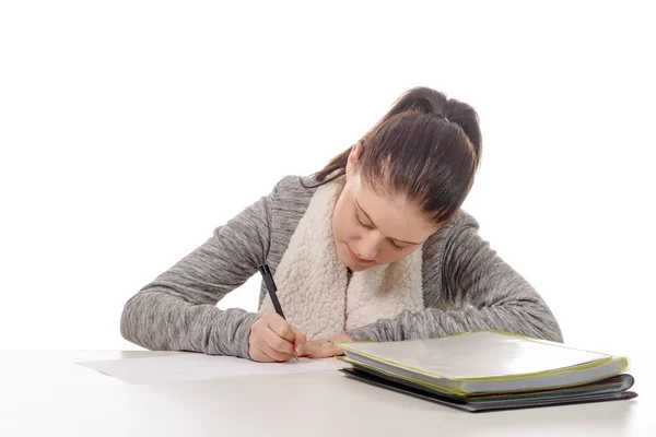 Pretty young woman writing on her desk — Stock Photo, Image