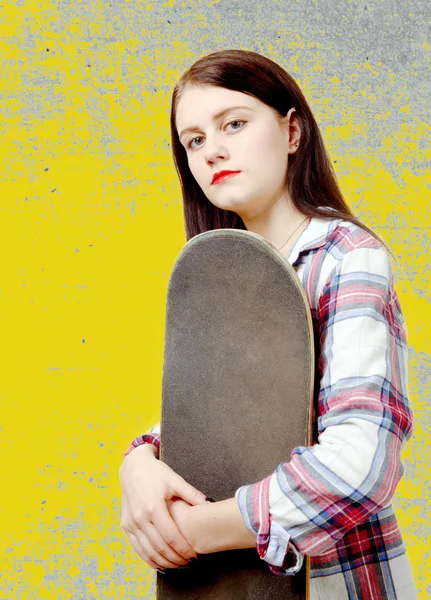 Portrait of young skater girl holding a skateboard — Stock Photo, Image