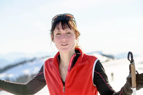 Junge glückliche Frau mit Skistöcken beim Winterskifahren — Stockfoto