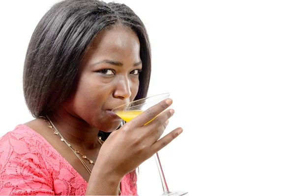 Красивая африканская женщина пьет апельсиновый сок — стоковое фото