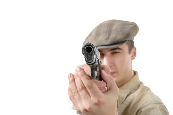 Joven disparando con un arma, ropa vintage, aislado en un wh —  Fotos de Stock