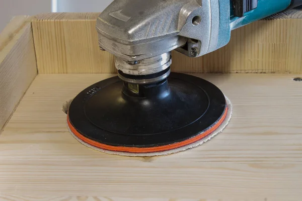 grinding with an electric wood grinder, restoration of solid wood furniture. Woodwork.
