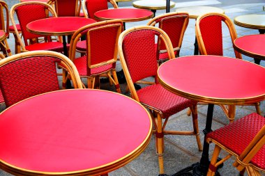  kırmızı hasır sandalye arka plan çok rattan sandalye ve masalar sokak karoları gri bir arka plan üzerinde yaz terasında sokakta bir kafede altın boru ile pürüzsüz kırmızı