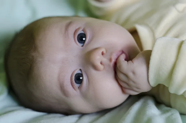 A cute little baby is looking into the camera — Stock Photo, Image