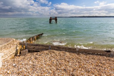 Remains of pier used to load ships doe World War II Normandy Lan clipart