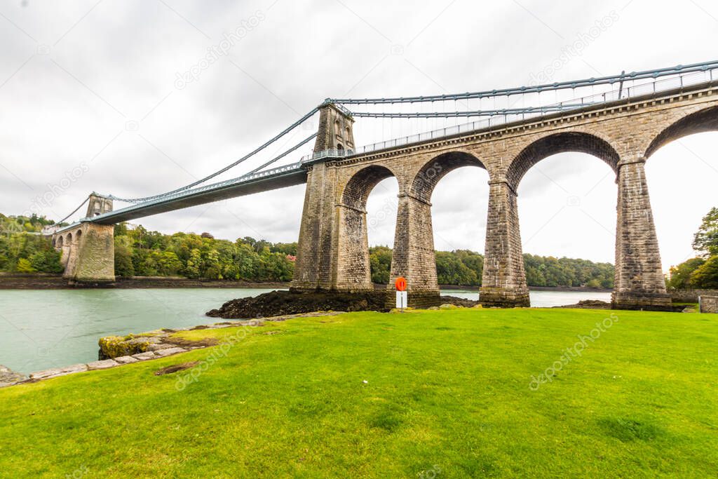 Menai Suspension Bridge designed by Thomas Telford, crosses the Menai Straits between Snowdonia and Anglesey, Wales, landscape, Wide Angle