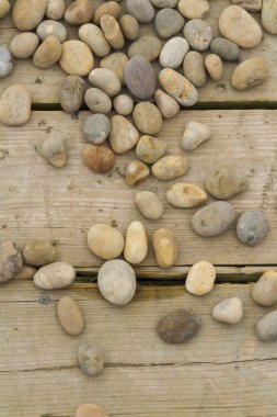 Pebbles  scattered on wood. clipart