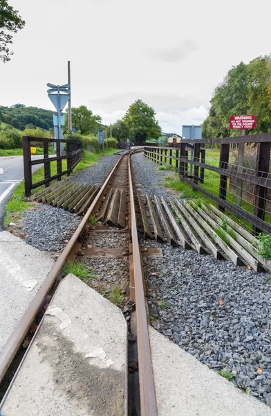 Narrow gauge railway or railroad track converging into distance — Stock Photo, Image