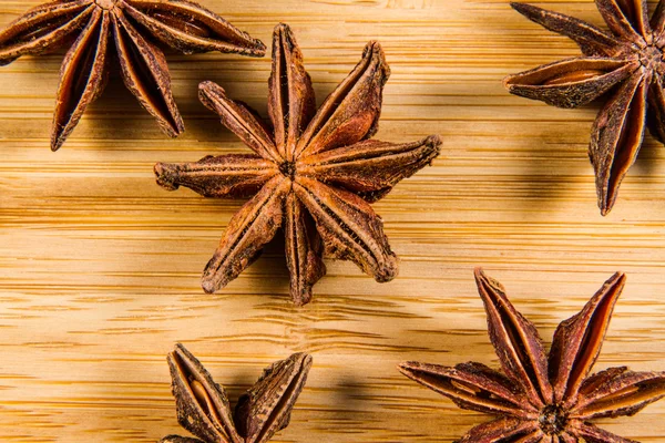 Star Anise, Illicium verum on a wood background. Close up.