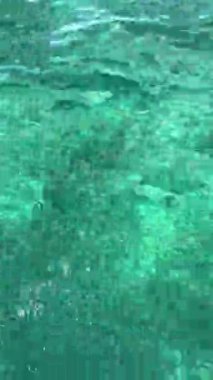 Close up shooting of the turquoise and jade green waters of the Caribbean Sea. Incredible colors, vacation mood, serene atmosphere.