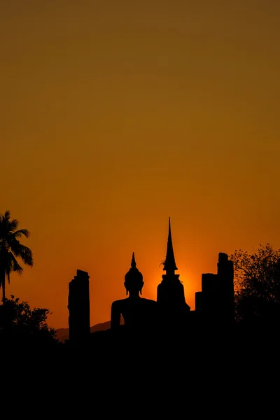 Silhouetteat de Buda e pagada na hora do pôr do sol no Parque Histórico de Sukhothai Tailândia . — Fotografia de Stock