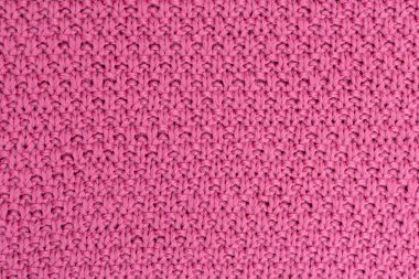 Pembe örülmüş kumaş inci yünlü arka plan. Kumaşın doğal bir dokusu var. Kumaş arka plan. Örülmüş yün arkaplan.