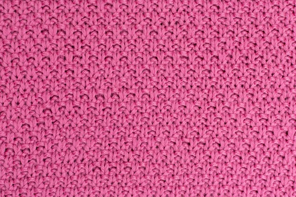 ピンクのニット生地パールウールの背景。自然な質感の生地の構造。ファブリックの背景。ニットウールの背景. — ストック写真
