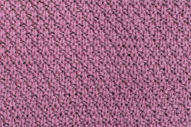 Örgü örülmüş inci yünlü arka plan. Kumaşın doğal bir dokusu var. Kumaş arka plan. Örülmüş yün arkaplan.