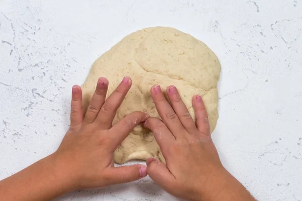Childrens hands sculpt salty dough. Development of fine motor skills of the hands. Development of childrens creativity.