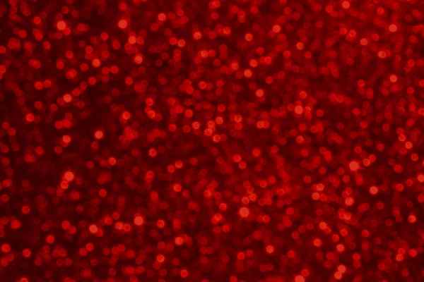 Işıl ışıl parıldayan kırmızı bokeh dokusu, festival kampanyaları ve kutlamalar için ideal..