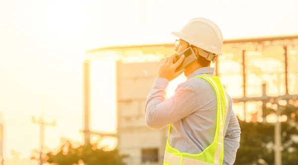 Engineer talk on mobile phone at construction site