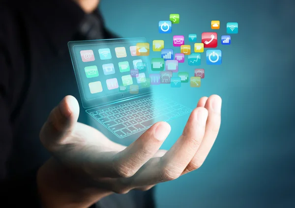 Portátil de pantalla táctil con iconos de aplicación coloridos en mano de hombre de negocios —  Fotos de Stock