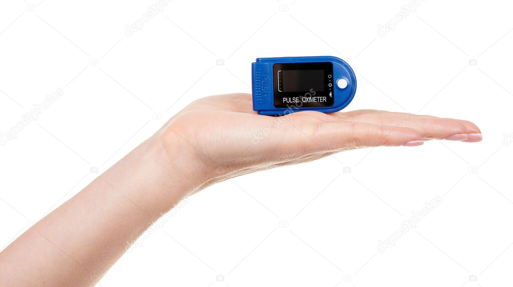 Hand with medical oximeter isolated on white.