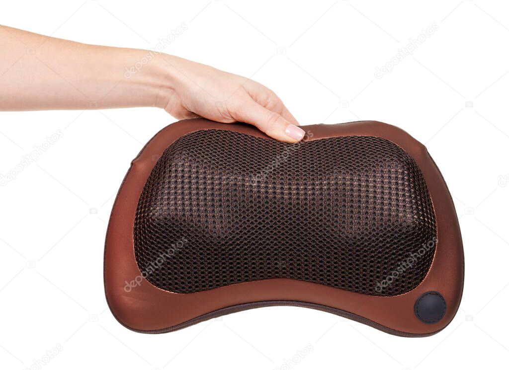 Hand with brown neck massage pillow isolated on white.