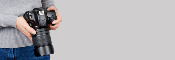 Hand with black photo camera.