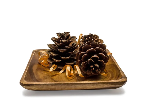 Wooden plate with pine cones — Stock Photo, Image