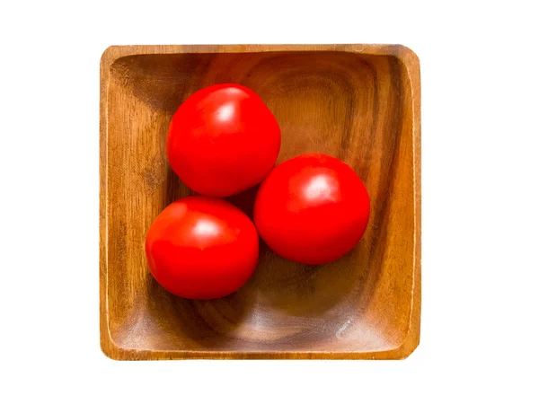 Tomatoes on wooden plate — Stock Photo, Image