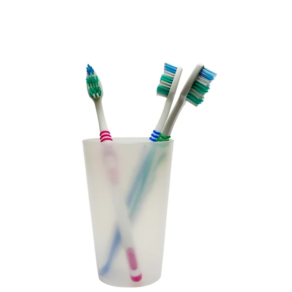 Tandenborstels in een tandenborstel tuimelaar — Stockfoto
